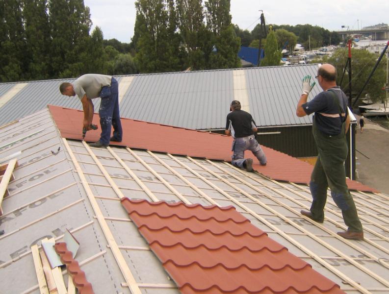 woodenhouse-058.jpg - Op condensfolie (Tyvec) worden de latten gelegd waarop de dakplaten worden bevestigd .Voor deze dakbedekking is gekozen vanwege de prijs en vanwege de helling van het dak  die maar 17% bedraagt. Pannen zouden kunnen loswaaien.